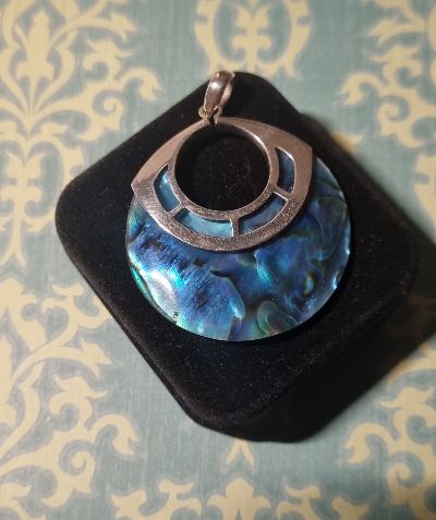 Blue iridescent pendant with silver-tone frame