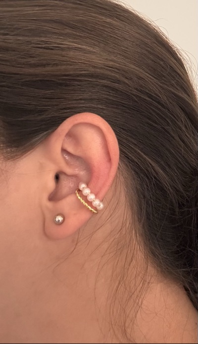 Gold-tone twisted ear cuff with white bead detail